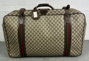 GUCCI LUGGAGE: A VINTAGE GUCCI SUITCASE, Gucci monogram throughout with brown stitched leather