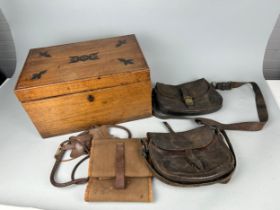 A COLLECTION OF WORLD WAR II LEATHER CARTRIDGE BAGS INSIDE A PINE AND IRON BOUND CASKET