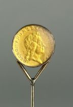 A GEORGE I GOLD QUARTER GUINEA 1718, Mounted on a gold pin between glass. Weight: 5.2gms