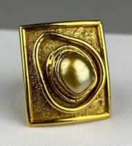 NEVIN HOLMES (TURKISH) AN 18T GOLD RING INSET WITH A PEARL, Born in Budapest, Nevin was the