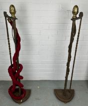 TWO METAL ROPE STANCHIONS, with brass pine cone detail and red rope, 106cm h (each) Used condition