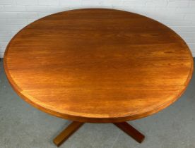 A HELTBORG MOBLER TEAK CIRCULAR EXTENDING DINING TABLE WITH TWO EXTRA LEAVES
