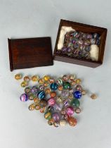 A COLLECTION OF ANTIQUE GLASS MARBLES SOME POSSIBLY LATE 19TH CENTURY (Qty), to include a box.