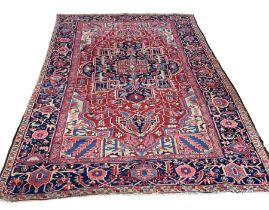 A LARGE ANTIQUE TURKISH RUG, 345CM X 235CM