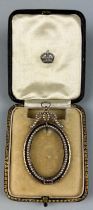 AN OVAL REGENCY STYLE SEED PEARL AND GOLD CAMEO FRAME, 19th century or earlier. In original