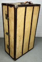 A LARGE BEIGE TRAVEL WARDROBE TRUNK WITH FITTED INTERIOR