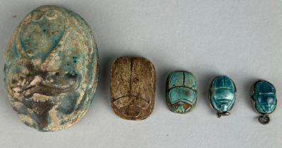 A COLLECTION OF FIVE EGYPTIAN SCARAB BEETLES POSSIBLY ANCIENT, Including four blue faience (one very
