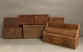 Seven oak carved boxes and an oak desk tidy