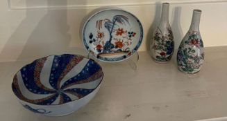 A selection of ceramics to include plates and a pair of vases