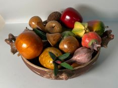 A wooden fruit bowl with carved wooden fruit