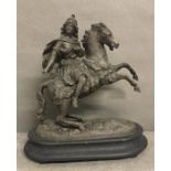 A pewter statue of a women on a prancing horse