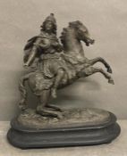 A pewter statue of a women on a prancing horse