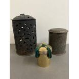 A metal candle holder and two lidded pots