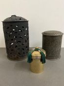 A metal candle holder and two lidded pots