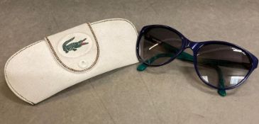 A pair of Lacoste ladies sun glasses in case