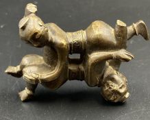 A bronze Chinese paperweight of two tumbling acrobats