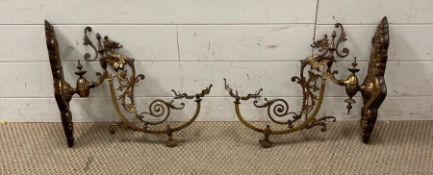 A pair of gilt bronze wall mounted lantern holders in the rococo style