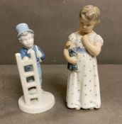 A Royal Copenhagen figure of a girl with a doll and a porcelain figure of a boy or a ladle