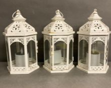 Three white metal octagonal lanterns with glass panels