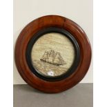 A mahogany circular framed needlework of a ship (Dia40cm) AF