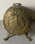 An antique brass scuttle in the form of a barrel