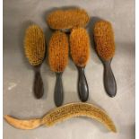 A selection of vintage hair brushes and a top hat brush