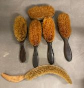 A selection of vintage hair brushes and a top hat brush