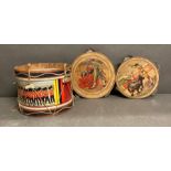 A vintage toy drum and two tambourines with matador detail