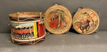 A vintage toy drum and two tambourines with matador detail