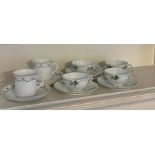 Four Bavarian pottery tea cups with shamrock pattern, stamped J C Juliette and a pair of bone