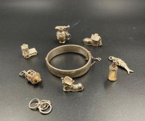 A selection of silver charms and a silver bracelet