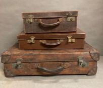 Three Vintage brown leather suitcases