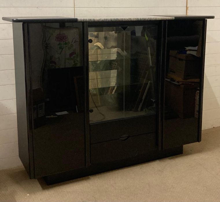 A marble centred black display cabinet with two drawers and cupboards to side (H130cm W176cm D50cm)