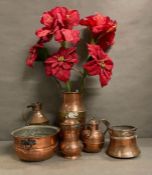 A selection of copper and brass items to include jugs, bowls and a milk churn