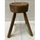 A rustic wooden stool on four legs (H47cm Dia28cm)