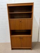 A teak free standing bookcase with shelves and drop bureau and cupboard under (H193cm W90cm D48cm)