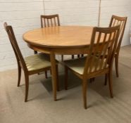 A Mid Century G-Plan circular extending dining table and four chairs (Dia120cm)