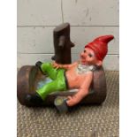 A garden gnome resting on a log after a few beers (H26cm)