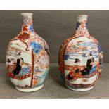 A pair of Imari pattern bottle vases