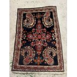 A Persian style rug with four carp fish design to each corner (120cm x 70cm)