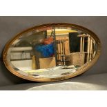 A Mid Century gilt framed oval wall mirror