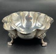 A silver bowl on four lion paw feet, hallmarked for London 1906 Horace Woodward & Co Ltd