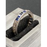 A diamond and sapphire eternity ring.(Size L)