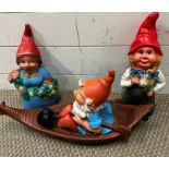 Two garden gnomes lady or gnomess and one in a boat