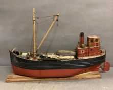 A hand painted model of a north sea trawler on plinth