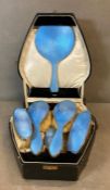A six piece silver and blue enamel dressing set by Charles S Green & Co Ltd and hallmarked for