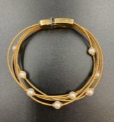 An 18ct gold Mappin & Webb bracelet with individual pearl decoration