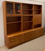 A large G-Plan modular wall unit with a pull down cupboard opening to mirrored cabinet (H198cm