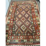 A hand knotted Aztec style rug (310cm x 202cm)