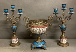 A porcelain and metal three piece garniture set with floral detail